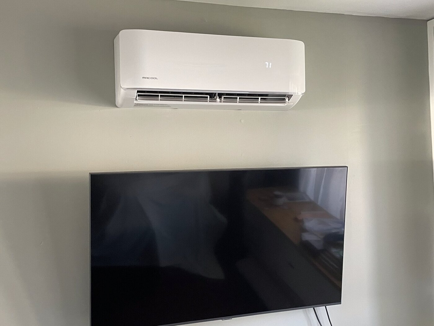 Installed MRCOOL mini-split head above a wall-mounted TV, Long Island NY